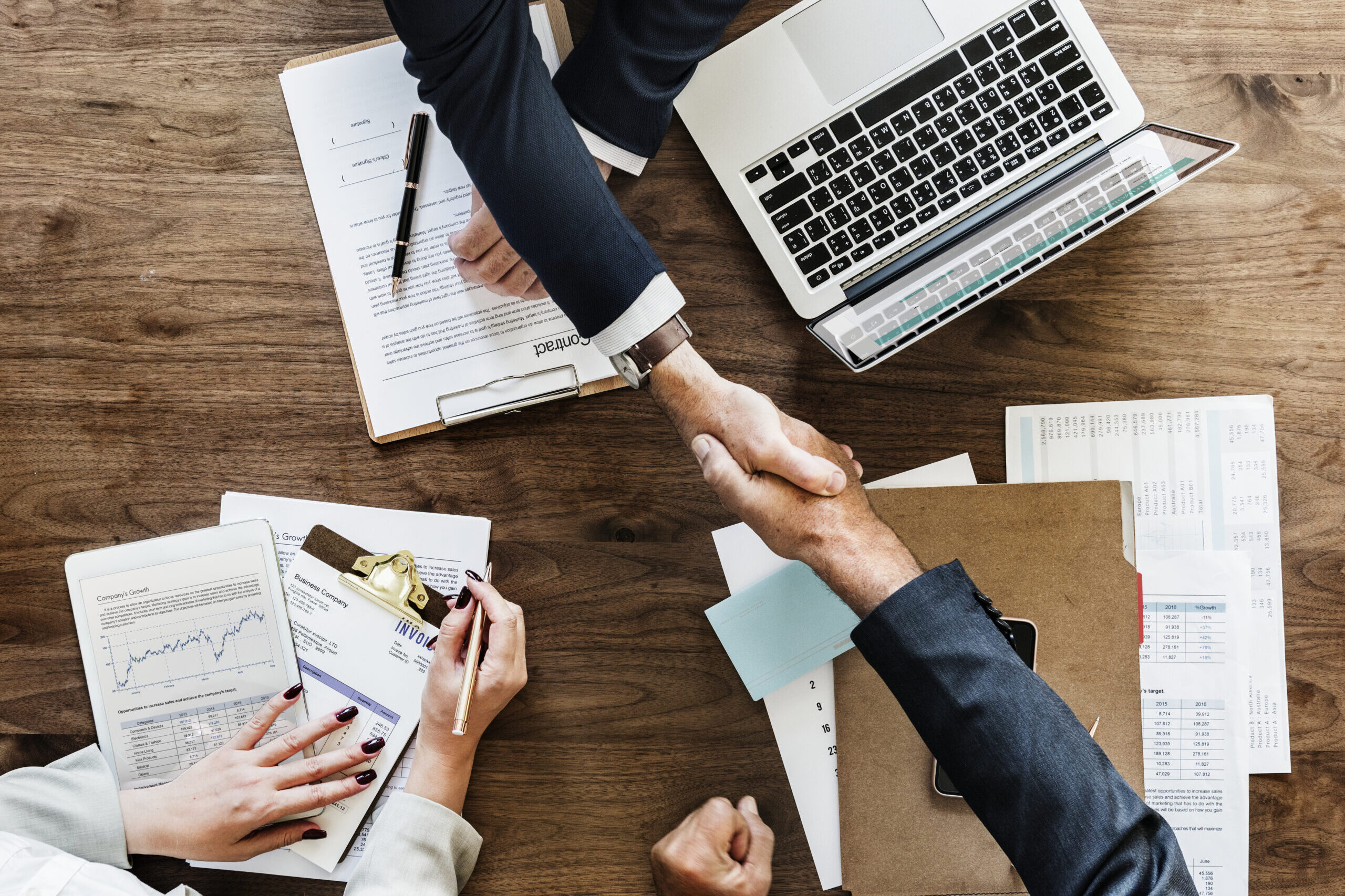 Business people shaking hands together